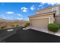 Spacious two-car garage with extended driveway and desert landscaping at 2894 Via Firenze, Henderson, NV 89044