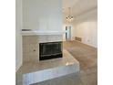 Living room fireplace, neutral color scheme, carpet, and chandelier at 3104 Archwood Way, Las Vegas, NV 89134