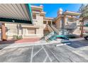 Two-story condo building exterior featuring stairs, and assigned parking at 312 Manti Pl, Henderson, NV 89014