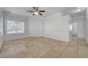 Bright living room with tile flooring, ceiling fan, and natural light from the window at 3705 Covewick Dr, North Las Vegas, NV 89032