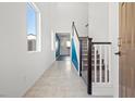 Bright entryway featuring a staircase and tile flooring at 430 Shimmering Sands Ave, North Las Vegas, NV 89031