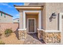 Inviting front entrance with stone accents and covered porch at 430 Shimmering Sands Ave, North Las Vegas, NV 89031