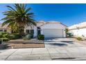 Charming single-story home with a well-maintained front yard, a palm tree, and a two-car garage at 4421 Rodman Dr, Las Vegas, NV 89130