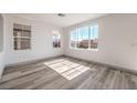 Sunlit bedroom boasting wood-look flooring and large windows providing plenty of natural light, creating a relaxing atmosphere at 4473 Oberlander Ave, North Las Vegas, NV 89031