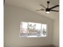 Light-filled bedroom featuring a ceiling fan and a large window showcasing the outside landscape at 4473 Oberlander Ave, North Las Vegas, NV 89031