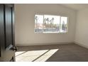 Bright bedroom with a large window offering outdoor views and neutral carpeting at 4473 Oberlander Ave, North Las Vegas, NV 89031