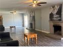 A spacious living room featuring a fireplace and mirrored walls at 4504 Cinderella Ln, Las Vegas, NV 89102