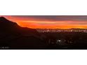 Gorgeous Las Vegas city view in a residential area at sunset with colorful clouds over the mountains at 4504 Eagle Nest Peak St, Las Vegas, NV 89129