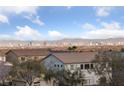 Expansive Las Vegas city view in a residential area during the day under a bright blue sky with clouds at 4504 Eagle Nest Peak St, Las Vegas, NV 89129