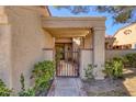 Welcoming home entrance with a gated walkway and lush desert landscaping at 4925 Turtle Point Dr, Las Vegas, NV 89113