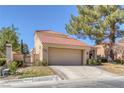 Beautiful home featuring a tile roof, desert landscaping and an attached garage at 4925 Turtle Point Dr, Las Vegas, NV 89113