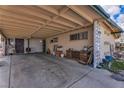 View of a spacious covered carport with storage and a glimpse of the backyard at 5125 Hallet Dr, Las Vegas, NV 89122