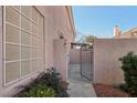 Charming exterior view highlighting the gated entryway and mature landscaping at 513 Rafkin Pl, Henderson, NV 89052