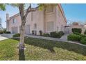 Inviting two-story home featuring lush greenery, a gated entrance, and a convenient two-car garage at 513 Rafkin Pl, Henderson, NV 89052