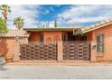 Close-up view of the home's decorative woven fence, terracotta roof, and unique architectural details at 5323 Taravilla Cir, Las Vegas, NV 89146