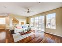 Bright and open-concept living room featuring hardwood floors, a modern sectional sofa, and natural light at 5850 Sonoma Station Ave, Las Vegas, NV 89139