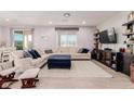 Comfortable living room with large sectional sofa and a view of the backyard at 6156 Ava Ridge Ave, Las Vegas, NV 89141