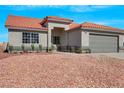 Charming single-story home with a terracotta tile roof, neutral stucco, and desert landscaping for easy maintenance at 6664 Rutgers Dr, Las Vegas, NV 89156