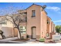 Charming two-story home with a tan exterior, balcony, and lovely curb appeal at 6687 Higger Tor Ave, Las Vegas, NV 89139