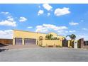 Beautiful exterior showing the house's facade, a three-car garage, gate, and an attractive landscaped front yard at 6760 Hinson St, Las Vegas, NV 89118