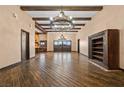 Spacious living room featuring high ceilings, exposed beams, and hardwood floors throughout at 6760 Hinson St, Las Vegas, NV 89118