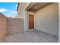 Inviting private, gated front patio with a paver floor and an attractive front door at 7707 W Diablo Dr, Las Vegas, NV 89113