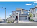 Contemporary two-story home featuring a two-car garage and modern architectural details during the day at 796 Keys View Ave, Las Vegas, NV 89138