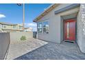 Charming home exterior featuring a red front door and paved entryway at 796 Keys View Ave, Las Vegas, NV 89138