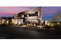 Stylish modern home exterior featuring unique architectural details, lush landscaping, and a welcoming entrance at 801 Dragons Eye Dr, Henderson, NV 89012