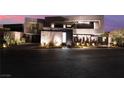 Modern home exterior featuring sleek architectural design, manicured landscaping, and inviting curb appeal in a serene setting at 801 Dragons Eye Dr, Henderson, NV 89012