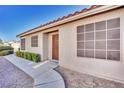 View of the entrance featuring a secure front door and gravel landscaping at 8024 Hurricane Cove Ct, Las Vegas, NV 89129