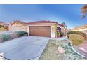 Single-story home with tile roof, tidy front yard, and a two-car garage at 8024 Hurricane Cove Ct, Las Vegas, NV 89129