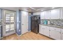 Traditional-style kitchen featuring white cabinets and a black refrigerator at 8229 Willeta Ave, Las Vegas, NV 89145