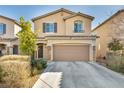 Inviting two-story home with stone accents, a two-car garage, and a well-maintained front yard at 854 Earth Luster Rd, Las Vegas, NV 89178