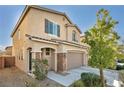 A two-story home with a two-car garage with stone accents and easy to care for desert landscaping at 854 Earth Luster Rd, Las Vegas, NV 89178