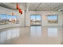 Spacious living room with modern lighting fixtures and large windows overlooking the city at 900 Las Vegas Blvd # 804, Las Vegas, NV 89101