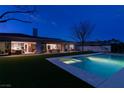 Stunning outdoor pool and spa area with sleek design and lush landscaping, perfect for relaxation and entertainment at 10313 Orkiney Dr, Las Vegas, NV 89144