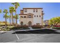 Three-story townhome featuring neutral stucco, a covered entry, and ample parking in front at 1092 Via Corto St, Henderson, NV 89011