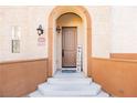 Inviting arched entryway with a wood door and welcome sign at 1092 Via Corto at 1092 Via Corto St, Henderson, NV 89011