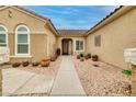 Attractive front entrance featuring desert landscaping with a walkway to the front door at 1616 Langston Hughes St, Henderson, NV 89052