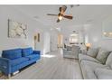 Spacious living room featuring wood floors, modern decor, and plenty of natural light at 1646 Little Crow Ave, Las Vegas, NV 89123