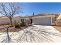 Inviting single-story home with a well-maintained driveway and desert landscaping at 1905 Sirocco Ct, Las Vegas, NV 89117