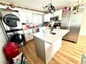 Modern kitchen with a center island, stainless appliances, and stacked washer and dryer at 1908 Linden Ave, Las Vegas, NV 89101