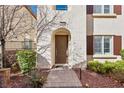 Inviting front entrance to a home with a decorative arched doorway, brick pavers, and neat landscaping at 1968 Granemore St, Las Vegas, NV 89135