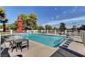 Community pool with ample seating and tables for residents at 2305 Plaza Del Grande, Las Vegas, NV 89102