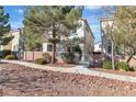 Two-story home with landscaped front yard, trees, and a brick wall at 3137 Sunrise Cove Ave, North Las Vegas, NV 89031