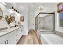 Modern bathroom with dual vanity, walk-in shower, and separate soaking tub at 343 American Dipper St, Las Vegas, NV 89138