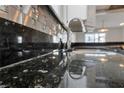 Close-up of granite countertop with mosaic backsplash and stainless steel faucet at 4272 E Russell Rd, Las Vegas, NV 89120