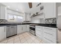 Bright kitchen featuring white cabinetry, stainless steel appliances, and dark countertops at 4272 E Russell Rd, Las Vegas, NV 89120