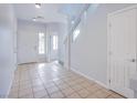 Open foyer features neutral walls, tile floors, and a staircase leading to the upper level at 5186 Bootlegger Ave, Las Vegas, NV 89141